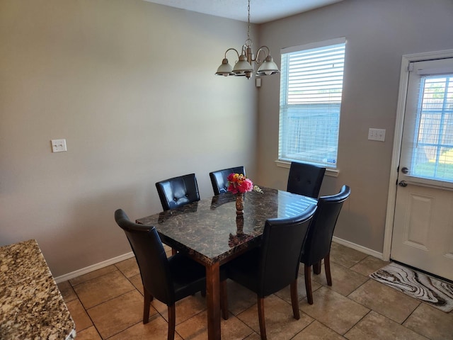 15903 Winston Point Ln, Houston, TX 77084 - dining area with a chandelier, baseboards, and light tile patterned flooring