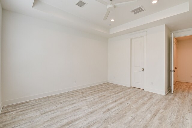2718 Oakwood Crest Ln, Houston, TX 77018 - unfurnished bedroom featuring recessed lighting, a tray ceiling, visible vents, and light wood-style floors