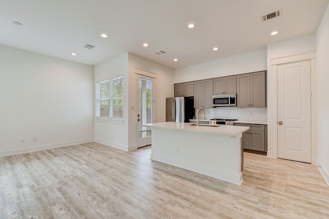 2718 Oakwood Crest Ln, Houston, TX 77018 - kitchen featuring visible vents, gray cabinets, stainless steel appliances, and a sink