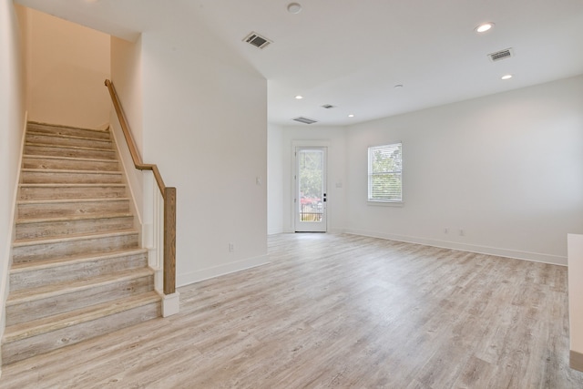 2718 Oakwood Crest Ln, Houston, TX 77018 - unfurnished living room with light wood-type flooring, visible vents, and stairs