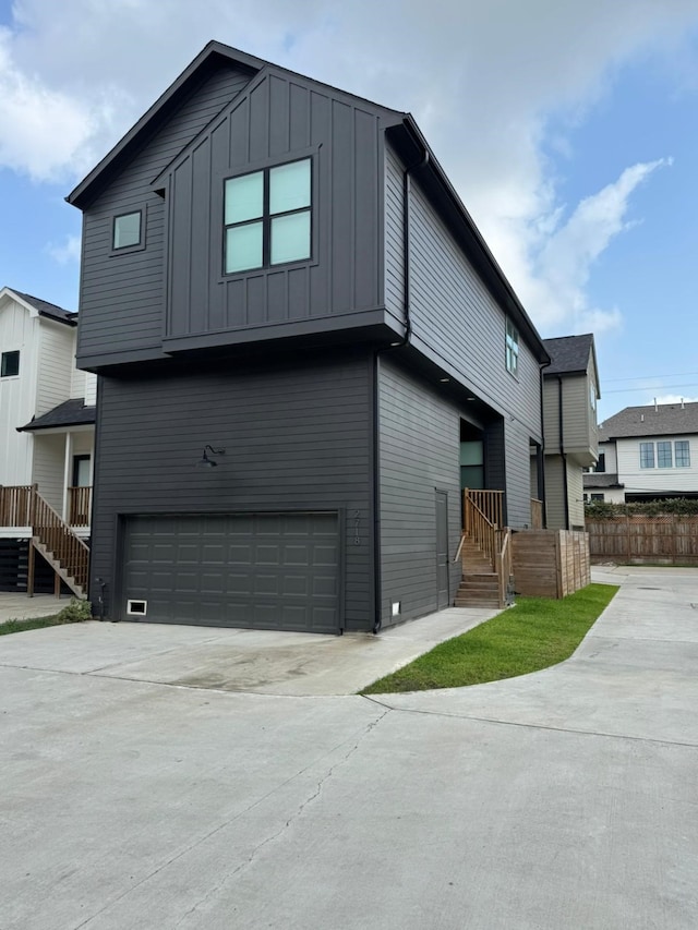 2718 Oakwood Crest Ln, Houston, TX 77018 - exterior space featuring fence, board and batten siding, concrete driveway, and an attached garage