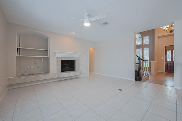 4530 Lakeside Meadow Dr, Missouri City, TX 77459 - unfurnished living room featuring stairway, tile patterned flooring, ceiling fan, a chandelier, and a fireplace