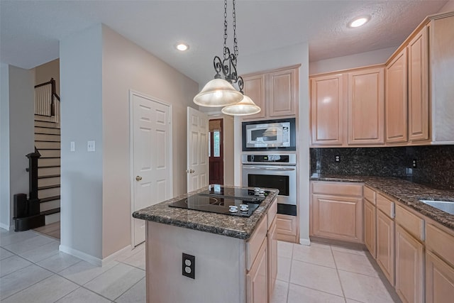 4530 Lakeside Meadow Dr, Missouri City, TX 77459 - kitchen with stainless steel appliances, light brown cabinetry, light tile patterned flooring, a center island, and recessed lighting