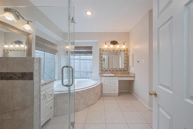 4530 Lakeside Meadow Dr, Missouri City, TX 77459 - full bathroom featuring tile patterned flooring, a shower stall, a garden tub, vanity, and baseboards
