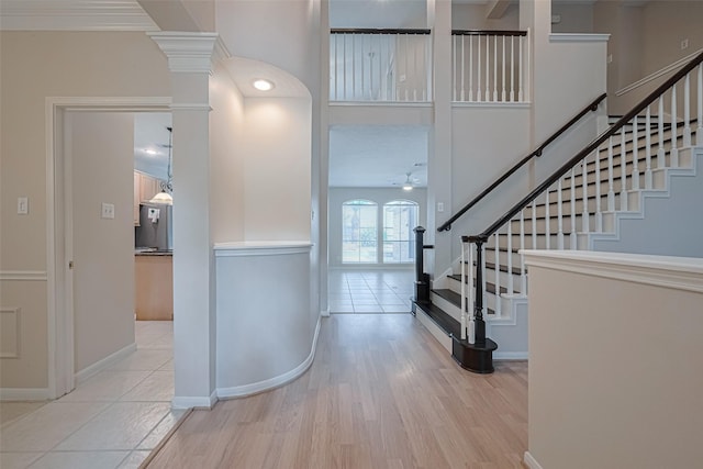 4530 Lakeside Meadow Dr, Missouri City, TX 77459 - foyer entrance featuring a ceiling fan, stairway, baseboards, wood finished floors, and a high ceiling