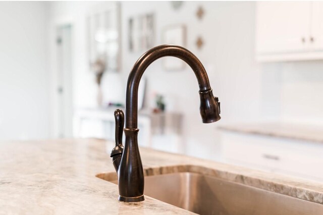 418 E St, East Bernard, TX 77435 - interior details with light stone countertops and a sink