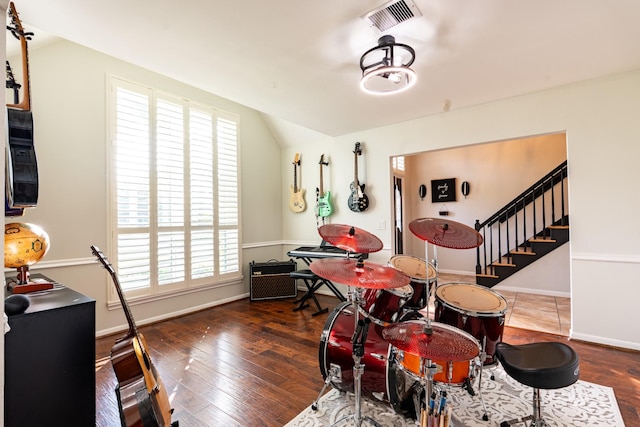 recreation room with wood finished floors, visible vents, and baseboards