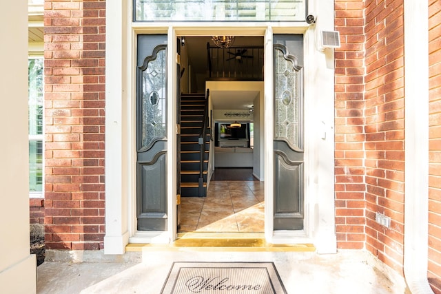doorway to property featuring brick siding