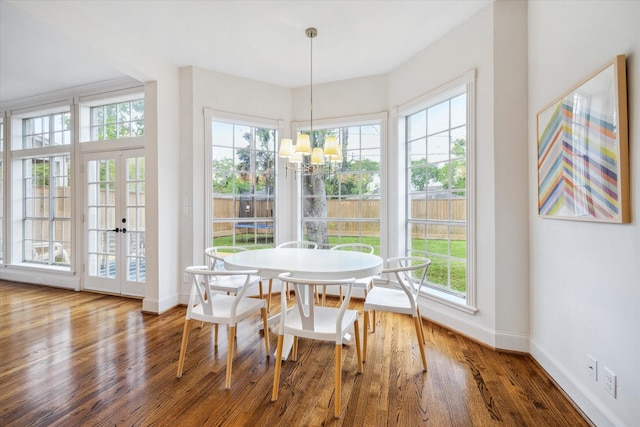 interior space featuring plenty of natural light, french doors, and an inviting chandelier