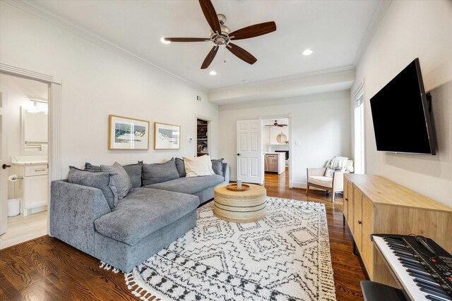 living room with a ceiling fan, recessed lighting, dark wood-type flooring, and crown molding