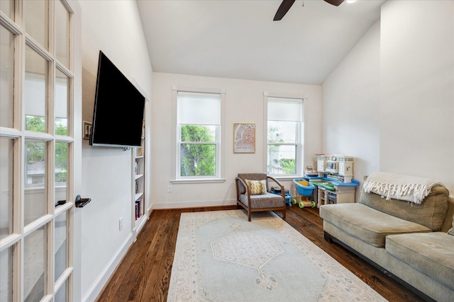 sitting room featuring dark wood finished floors, ceiling fan, vaulted ceiling, and baseboards