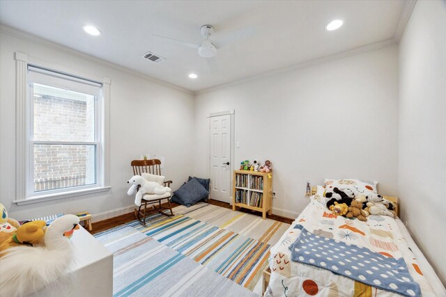 bedroom with wood finished floors, visible vents, recessed lighting, and ornamental molding