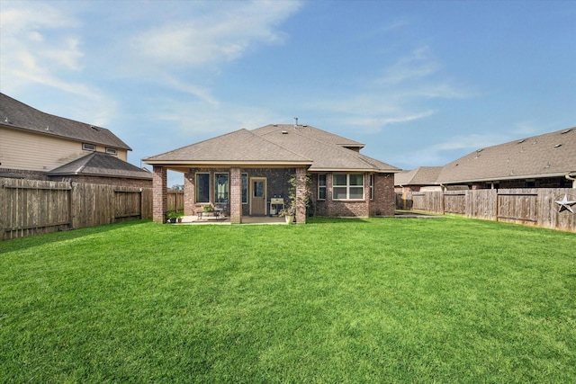 2807 Merlin Ln, Pearland, TX 77581 - back of house featuring a yard, brick siding, a patio area, and a fenced backyard