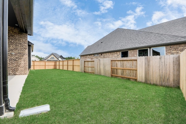 view of yard with a fenced backyard