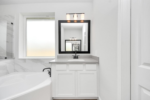 bathroom featuring vanity, a garden tub, and a shower