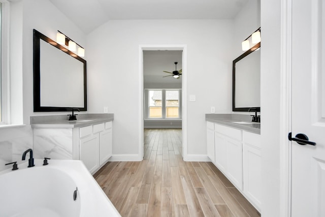 bathroom featuring a sink, baseboards, a ceiling fan, and wood finished floors