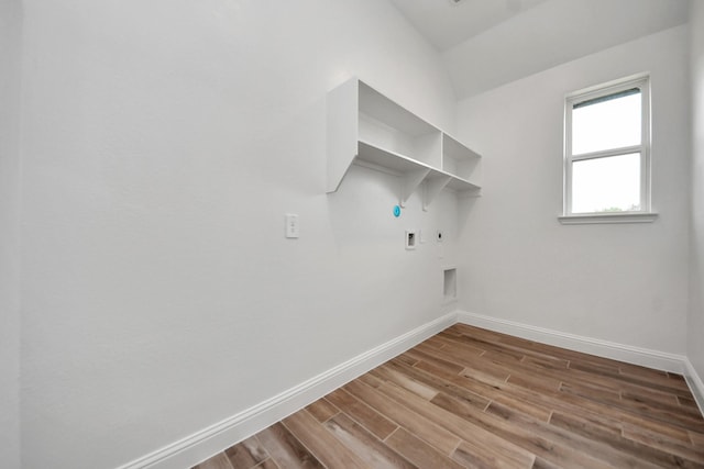 laundry area with wood finished floors, electric dryer hookup, laundry area, hookup for a gas dryer, and baseboards