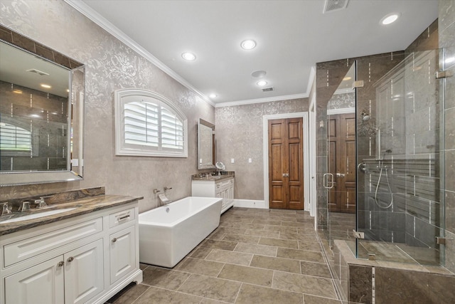 full bathroom with crown molding, a shower stall, two vanities, a sink, and a soaking tub