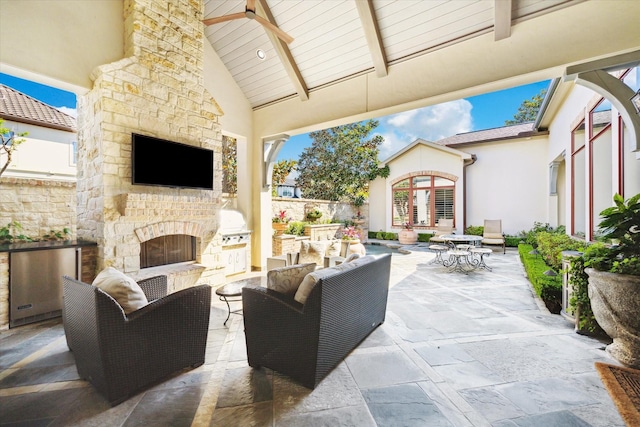 view of patio / terrace with french doors and an outdoor living space with a fireplace