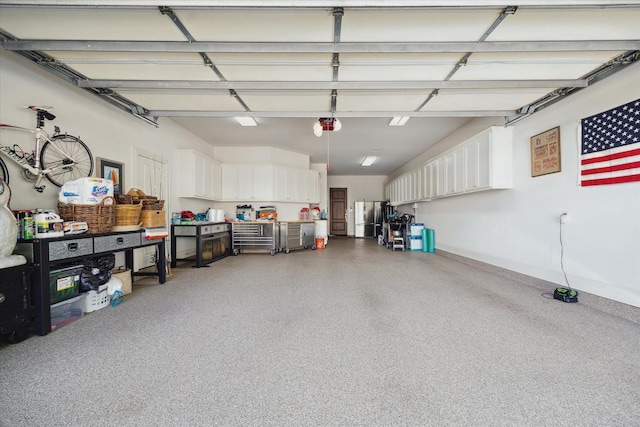 garage with freestanding refrigerator and a garage door opener