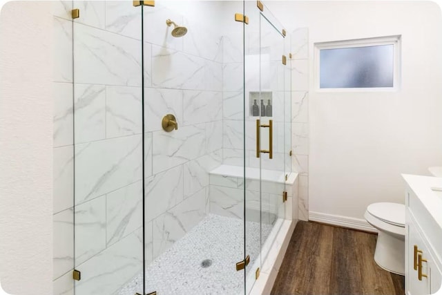 2205 Rosewood St, Houston, TX 77004 - bathroom with toilet, wood finished floors, a stall shower, vanity, and baseboards