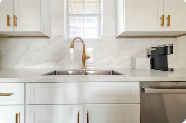 2205 Rosewood St, Houston, TX 77004 - room details with stainless steel dishwasher, white cabinetry, a sink, and light countertops