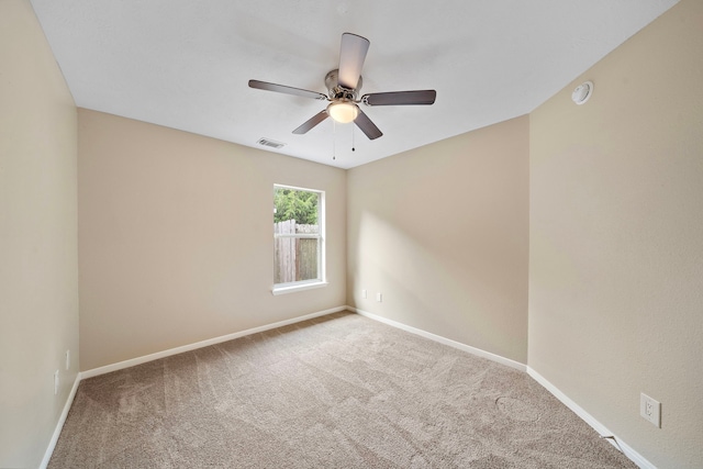 empty room with visible vents, ceiling fan, baseboards, and carpet floors