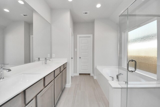full bathroom with recessed lighting, a bath, visible vents, and a sink