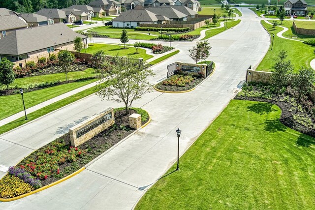 surrounding community featuring a residential view and curved driveway