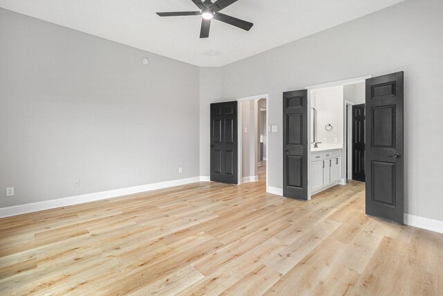 unfurnished bedroom featuring light wood-type flooring, a ceiling fan, and baseboards