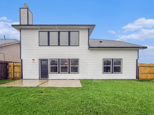 back of property featuring a patio area, a chimney, a lawn, a fenced backyard, and roof with shingles