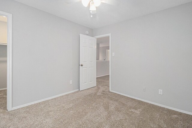 unfurnished room featuring baseboards, a ceiling fan, and carpet flooring