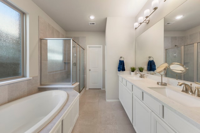32055 August Woods Way, Conroe, TX 77385 - bathroom featuring double vanity, a sink, visible vents, and a stall shower
