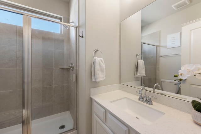 32055 August Woods Way, Conroe, TX 77385 - bathroom featuring vanity, visible vents, a shower stall, and toilet