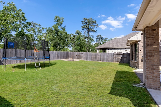 32055 August Woods Way, Conroe, TX 77385 - view of yard featuring a fenced backyard and a trampoline