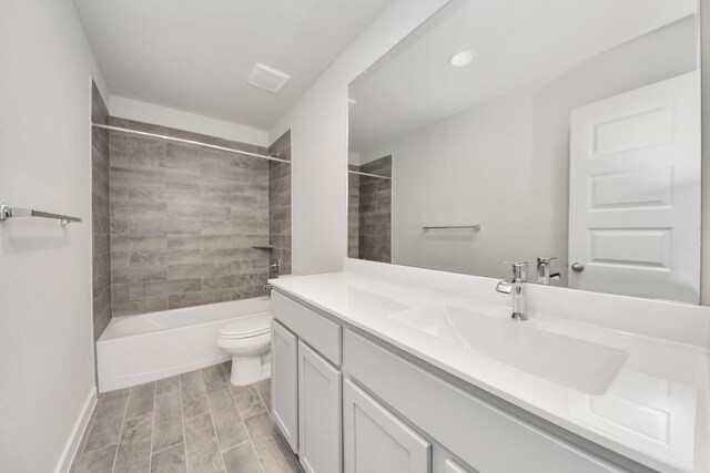 full bathroom featuring wood tiled floor, vanity, bathtub / shower combination, baseboards, and toilet