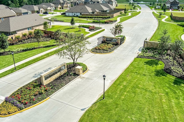 surrounding community featuring a residential view and curved driveway