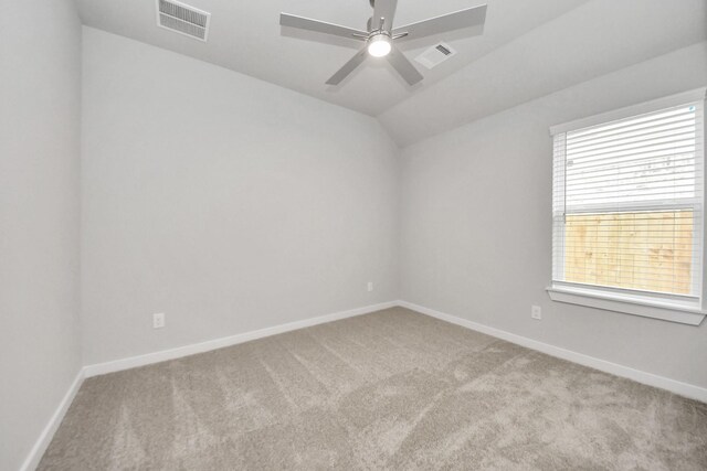 unfurnished room with ceiling fan, light carpet, and visible vents