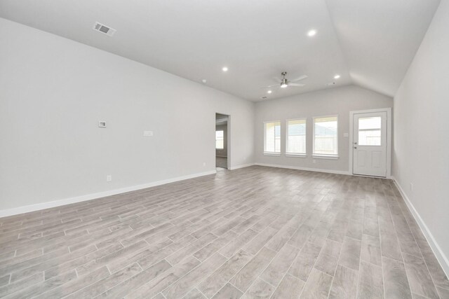 unfurnished living room with vaulted ceiling, a ceiling fan, light wood-type flooring, visible vents, and recessed lighting