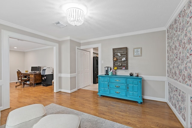 interior space featuring light wood-type flooring, visible vents, an inviting chandelier, and crown molding