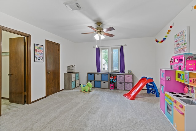 playroom featuring visible vents, carpet flooring, baseboards, and ceiling fan