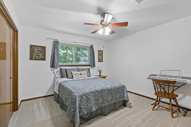 carpeted bedroom featuring a ceiling fan and baseboards