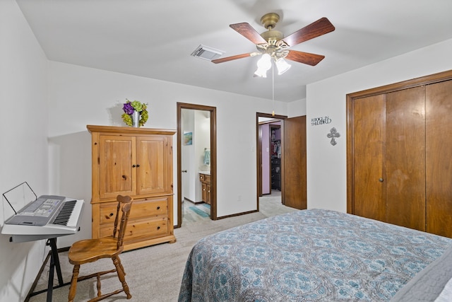bedroom featuring visible vents, a ceiling fan, light carpet, a closet, and baseboards