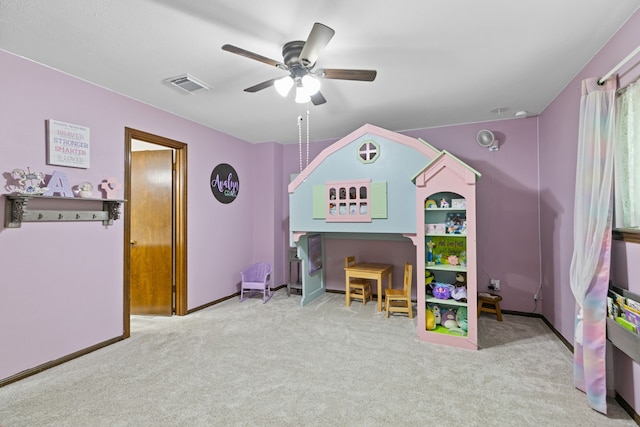 carpeted bedroom featuring baseboards, a ceiling fan, and visible vents