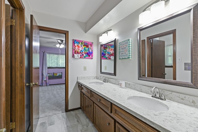 bathroom with double vanity, ceiling fan, and a sink