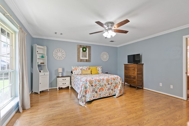 bedroom featuring light wood-type flooring and ornamental molding