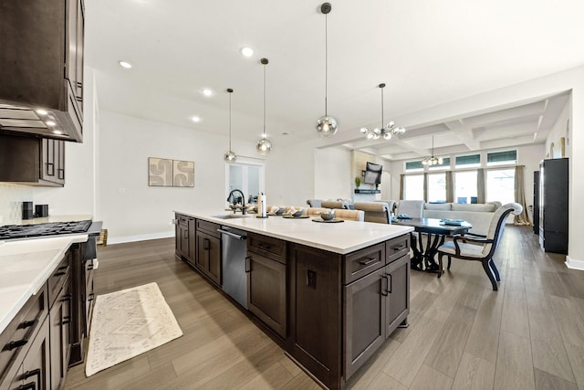 kitchen featuring open floor plan, coffered ceiling, dishwasher, and dark brown cabinets