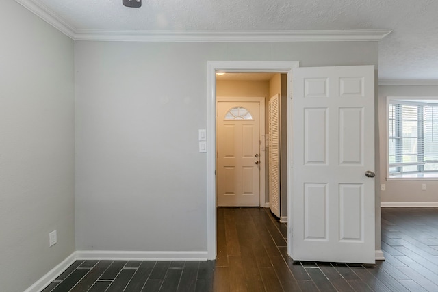 foyer entrance featuring baseboards, ornamental molding, and dark wood-style floors