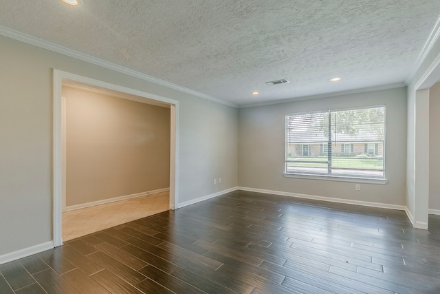 empty room with crown molding, a textured ceiling, dark wood-style floors, and baseboards