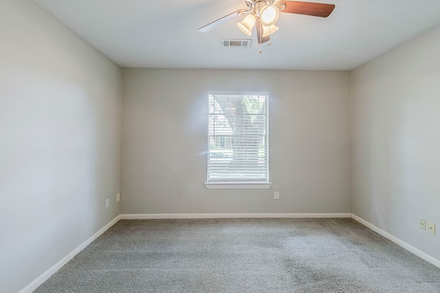 unfurnished room with visible vents, a ceiling fan, baseboards, and carpet floors